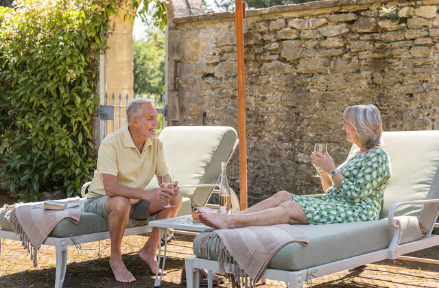 Couple relaxing on the terrace at Newton Surmaville 